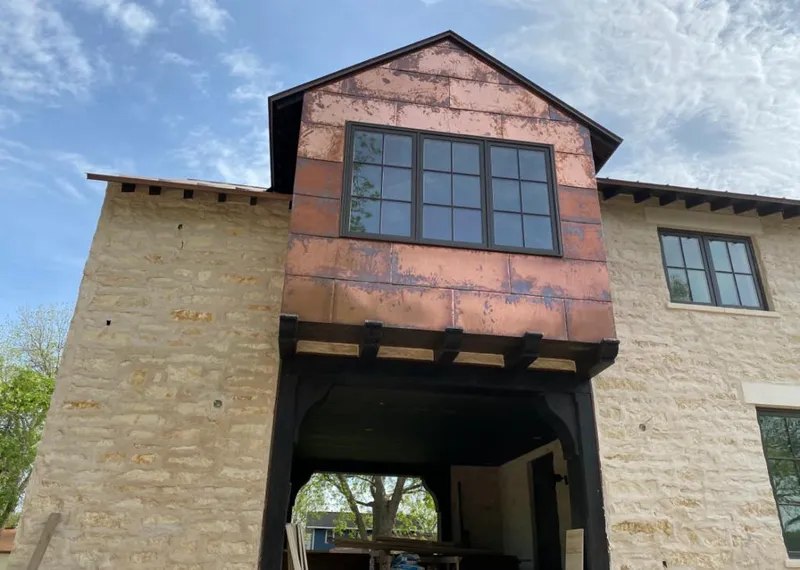 Copper metal panel facade on a stone building for Skylight Installation in Waxahachie